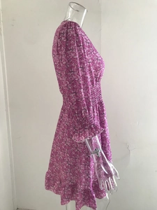 Detail view of purple floral print dress with elastic smocked waist and ruffled cuffs