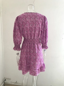 Detailed view of pink floral chiffon dress with smocked waist and elastic puff sleeves