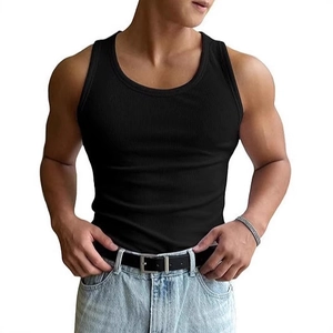 Men's slim fit black ribbed workout tank top paired with denim jeans for fitness