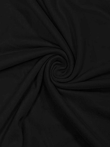 Macro texture view of soft black knitted fabric with elegant drapes and folds