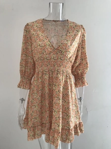 Detail of V-neckline and elastic high waist on a bohemian floral midi dress