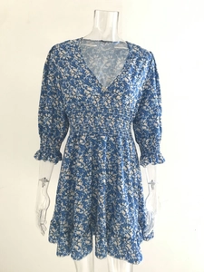 Close-up of the smocked elastic waist and blue floral pattern on this boho dress