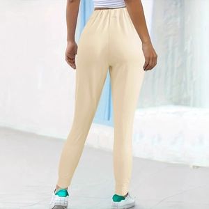 Women's apricot athletic joggers with elastic waist and ribbed cuffs, back view display