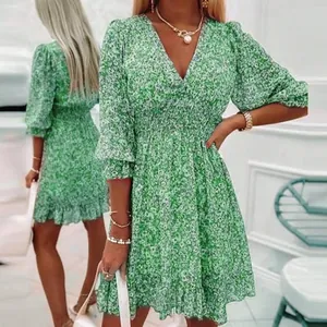 Bohemian floral V-neck dress with puff sleeves and elastic waist in green print