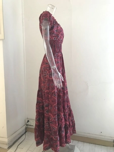 Detail view of red paisley print maxi dress with elastic waist and ruffle sleeves