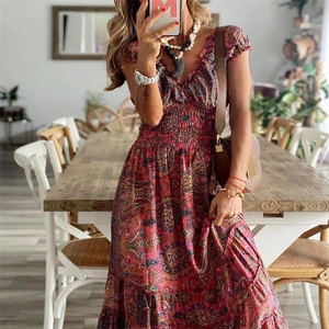 Detail of bohemian floral maxi dress featuring red paisley print and smocked waist