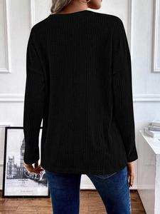 Back view of a black long-sleeved ribbed knit sweater with a relaxed drop-shoulder design