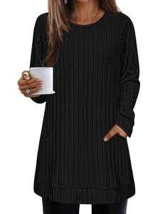Detail shot of the black ribbed knit texture and side pockets on a longline sweater