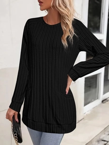 Detail view of the vertical ribbed texture and side pockets on a black knit tunic shirt