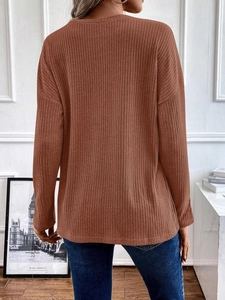 Detailed macro view of the brown ribbed knit texture on this casual long sleeve sweater