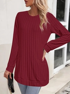Detail view of burgundy long sleeve knit sweater with ribbed texture and side pockets