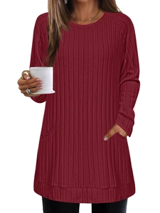 Detail of burgundy ribbed knit sweater dress with side pockets and long sleeves