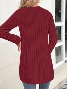 Back view of a woman wearing a casual burgundy long sleeve ribbed knit sweater top