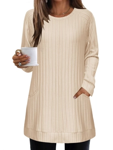 Detail of loose knit ribbed sweater featuring a round neck and side pockets in apricot