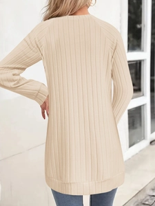 Detail of a beige ribbed knit tunic with long sleeves and loose fit back view
