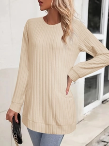 Close-up of light beige ribbed knit sweater texture with side pockets and round neck