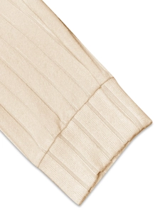 Detail of ribbed knit cuffs on beige long sleeve sweater showing soft texture