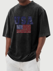 Close-up of vintage washed grey T-shirt featuring a distressed USA flag graphic print