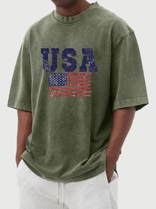 Close-up of vintage washed olive cotton T-shirt featuring a distressed USA flag print