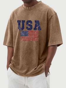 Close-up of distressed USA flag print and vintage washed fabric on brown t-shirt