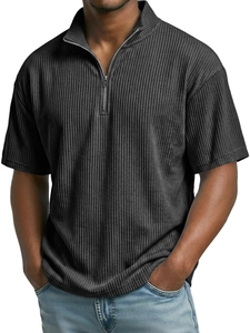 Close-up of dark grey corduroy polo shirt featuring a half-zip neckline and ribbed texture