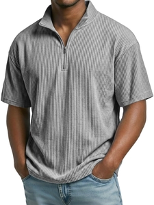 Detail of light grey corduroy polo shirt featuring vertical texture and half-zip neckline