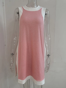 Detail view of pink sleeveless patchwork dress with white color block and side slit hem