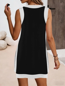 Back view of a sleeveless two-piece jumpsuit featuring black and white contrast stitching
