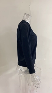 Detailed side view of black long sleeve ribbed knit sweater with round neck on a mannequin