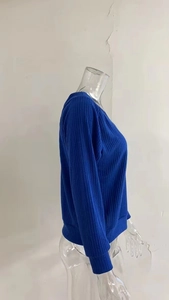 Detailed view of dark blue ribbed knit fabric with snug cuffs and elastic texture
