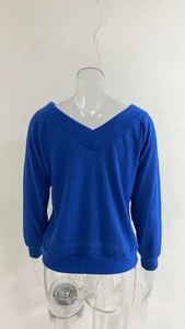 Detail view of the royal blue ribbed knit texture and V-neckline on the back of the sweater