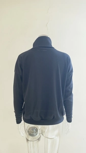 Rear view of a dark blue ribbed knit sweater featuring vertical stripes and high collar
