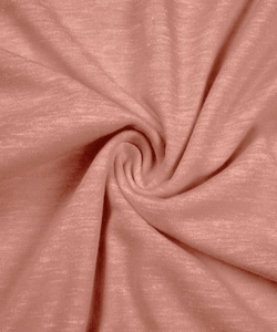 Detailed close-up of soft pink-orange knit fabric texture with mottled heather pattern