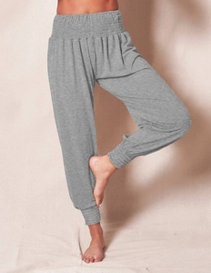 Close-up of women high waisted smocked yoga pants in heather grey with elastic cuffs