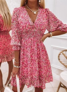 Detail showing pink floral boho dress with V-neck, elastic waist, and ruffled hemline