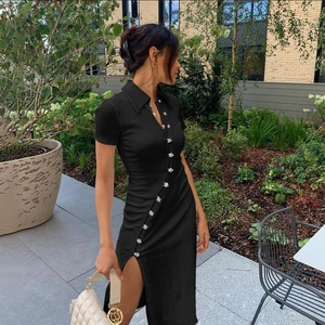 Detail of black ribbed knit dress featuring side button closure and elegant split hem
