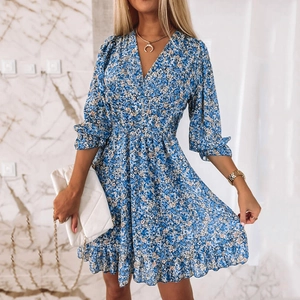 Detailed close-up of light blue floral dress with V-neckline and ruffled short sleeves
