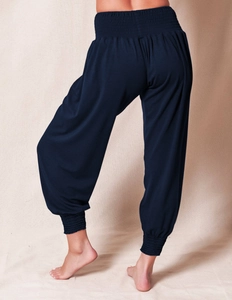 Detail of high waist pleated elastic band and back view of loose navy harem yoga pants