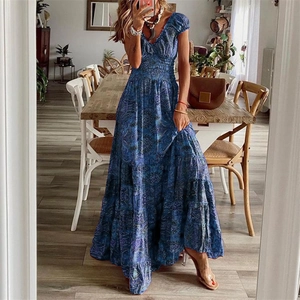 Close-up of smocked elastic waist and paisley print on Bohemian blue maxi dress