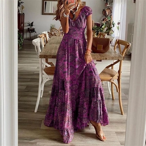 Close-up of smocked waist detail on a bohemian purple floral maxi dress