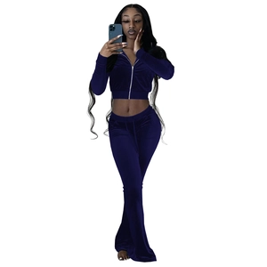 Detail of navy blue velvet two-piece set featuring cropped zip hoodie and flared trousers
