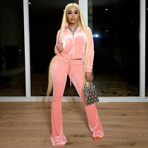 Detailed texture of pink velvet tracksuit with zipper jacket and flared trousers