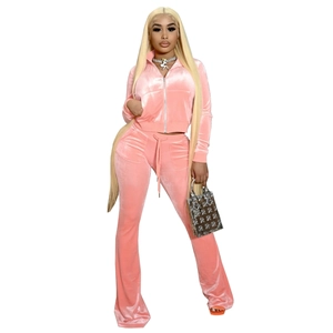 Pink velvet two-piece sportswear set featuring cropped zip jacket and flared pants
