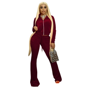 Detailed texture of burgundy velour tracksuit featuring a zip-up hoodie and flared pants