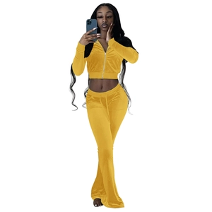 Detail of mustard yellow velvet tracksuit with cropped zip jacket and flare pants