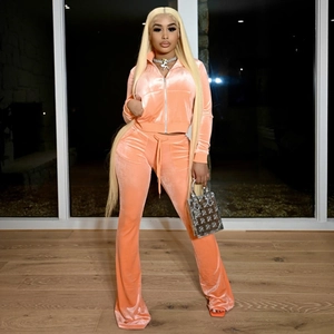 Detail of peach velvet tracksuit featuring zip-up cropped jacket and drawstring trousers