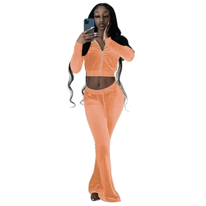 Detailed texture of peach velvet tracksuit featuring zip-up hoodie and flared pants