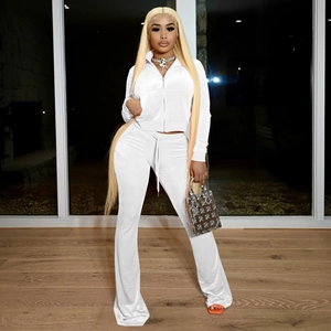 Detail of white velvet tracksuit featuring hooded zipper jacket and drawstring flared pants