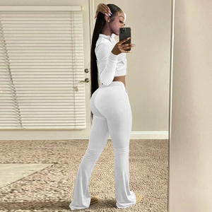 Close-up of white two-piece lounge set with high waist flared trousers and crop top