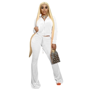 Detail of white velvet two-piece set featuring a zip-up top and high-waist flare pants